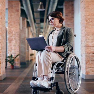 Staff-member-using-wheelchair-on-a-laptop